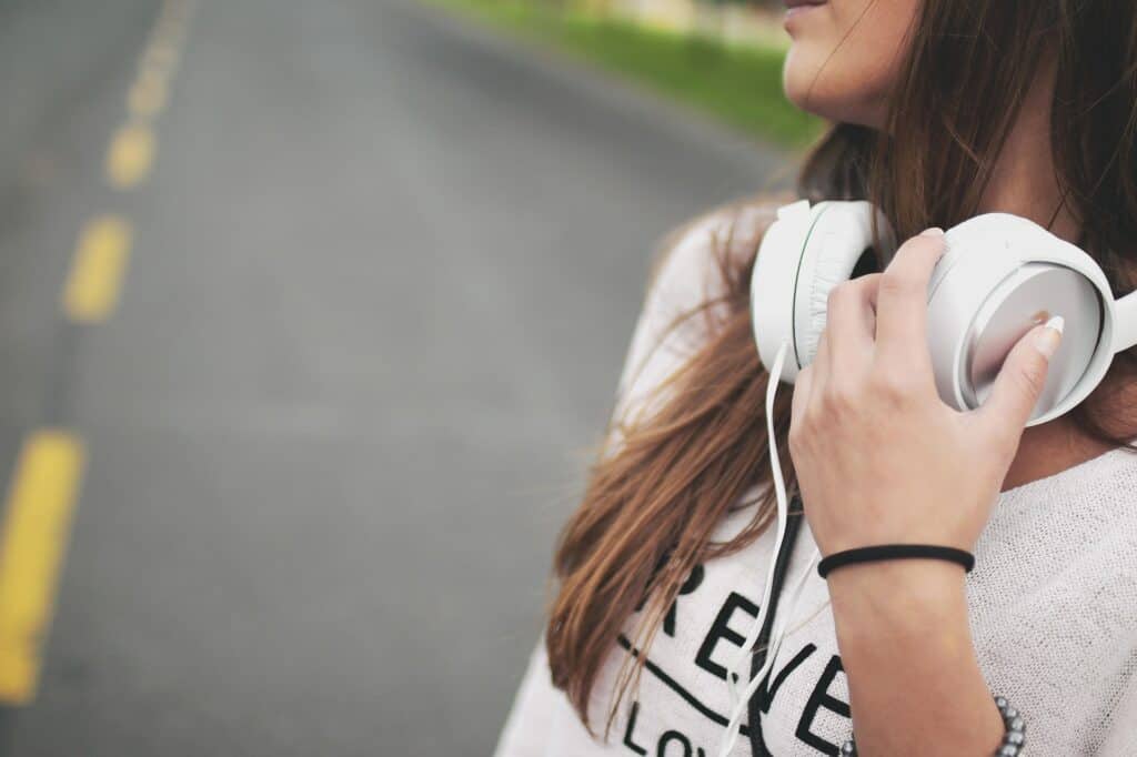Woman walking on road with headphones